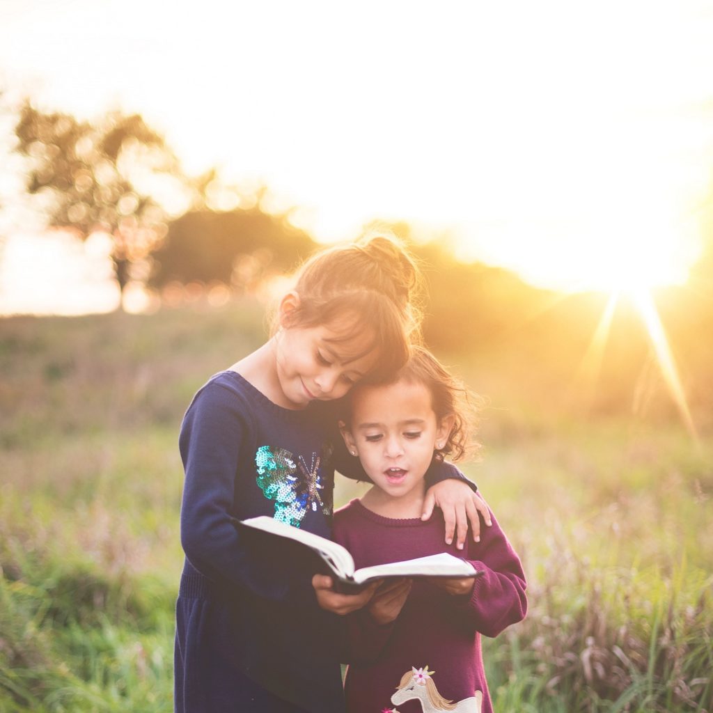 仲良く本を読む姉妹の画像